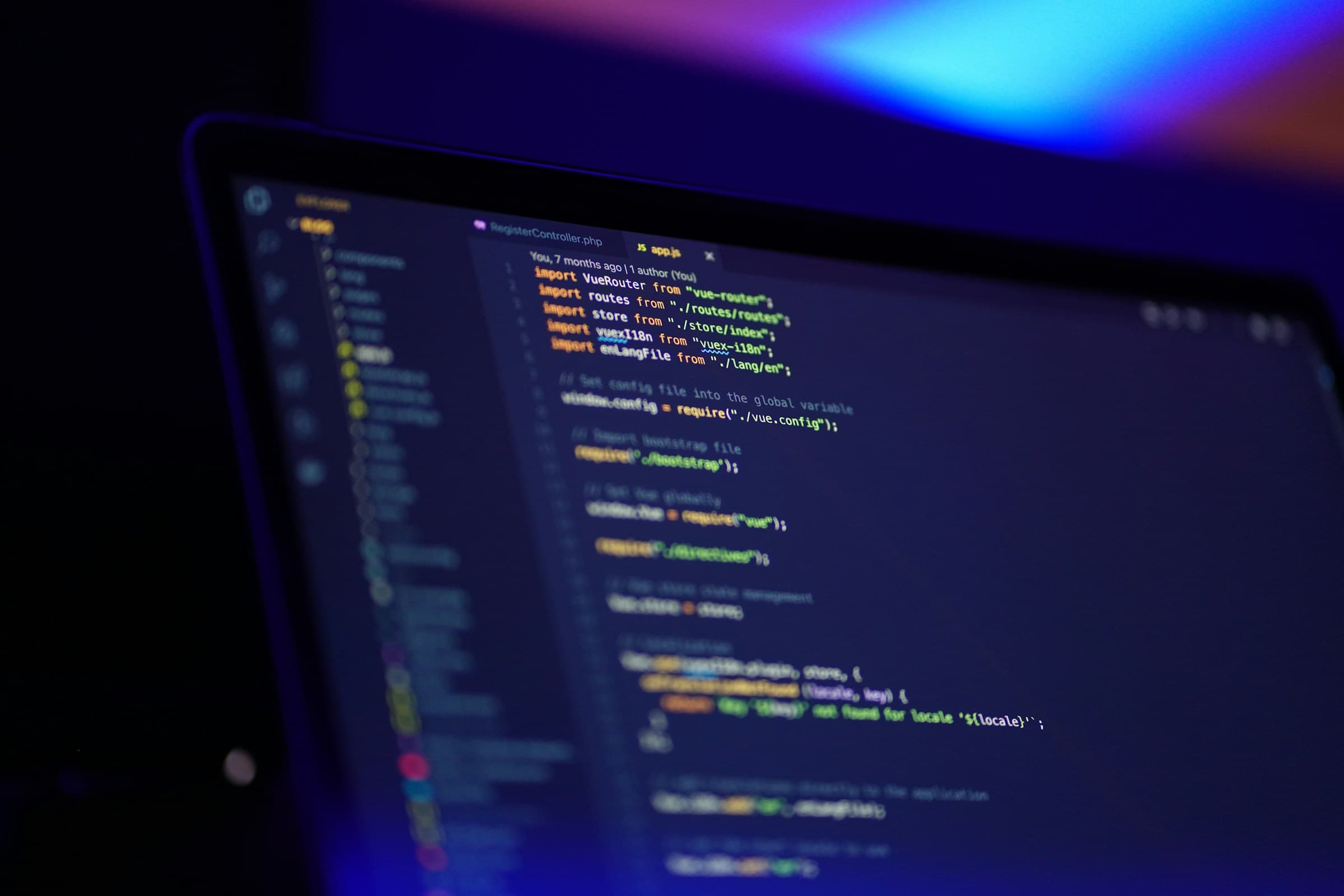 Laptop screen showing colorful Python code, representing a Django project