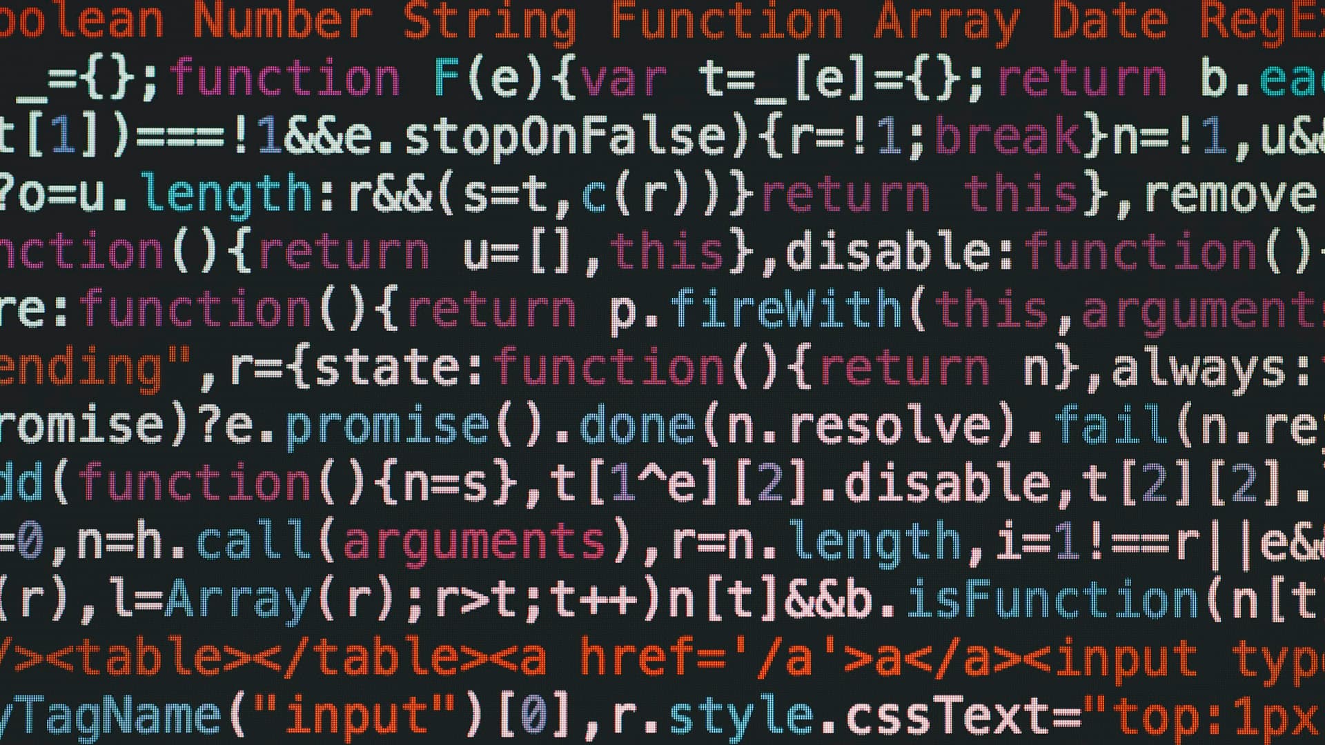 Laptop screen showing JavaScript source code in a dark editor